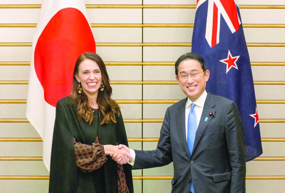 Japanese Prime Minister Fumio Kishida with New Zealand's Prime Minister Jacinda Ardern before their meeting at the prime minister's office in Tokyo on Thursday. - AFP