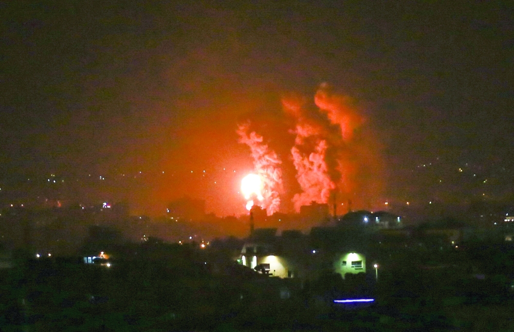 Flames and smoke rise over the central Gaza Strip as Israeli warplanes strike the territory. -- AFP