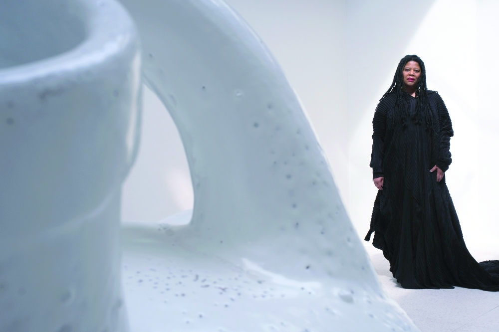 Simone Leigh with her new glazed stoneware work, "Jug," inside the U.S. Pavilion at the 59th International Venice Biennale, April 6, 2022.  (Sarah van Rij/The New York Times) 