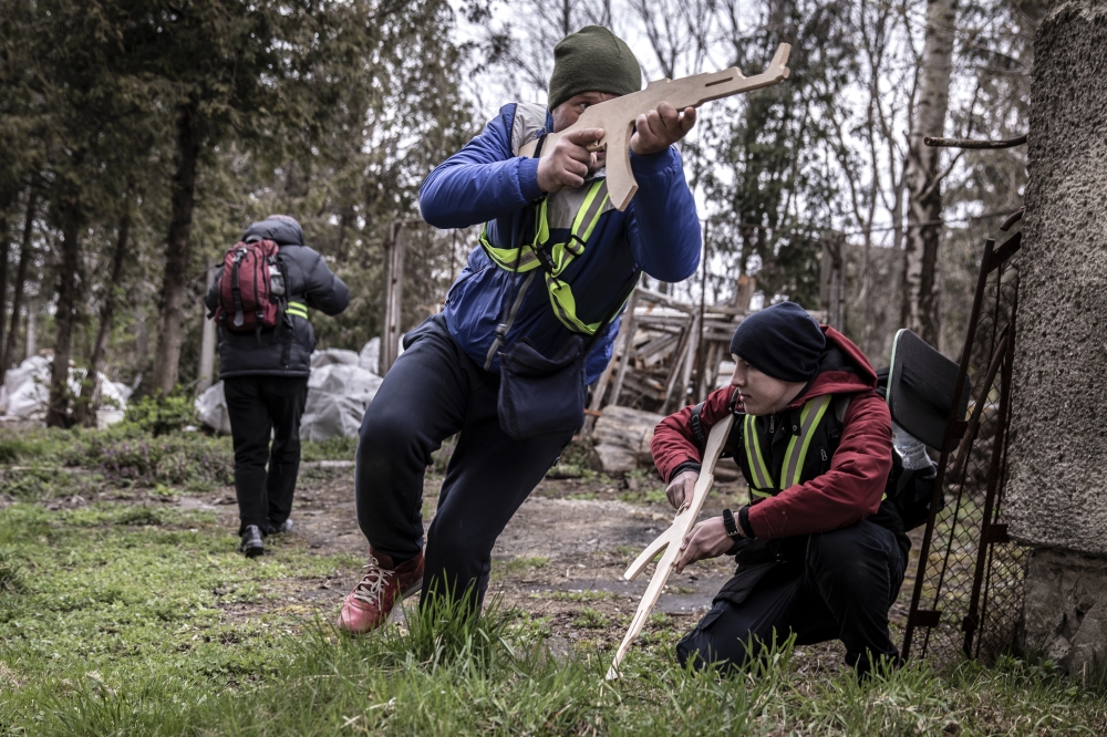 Civilians carrying wooden dummy rifles receive training on combat strategy and technique from Czech military volunteers in Lviv, Ukraine, April 21, 2022.  (Finbarr OReilly/The New York Times)