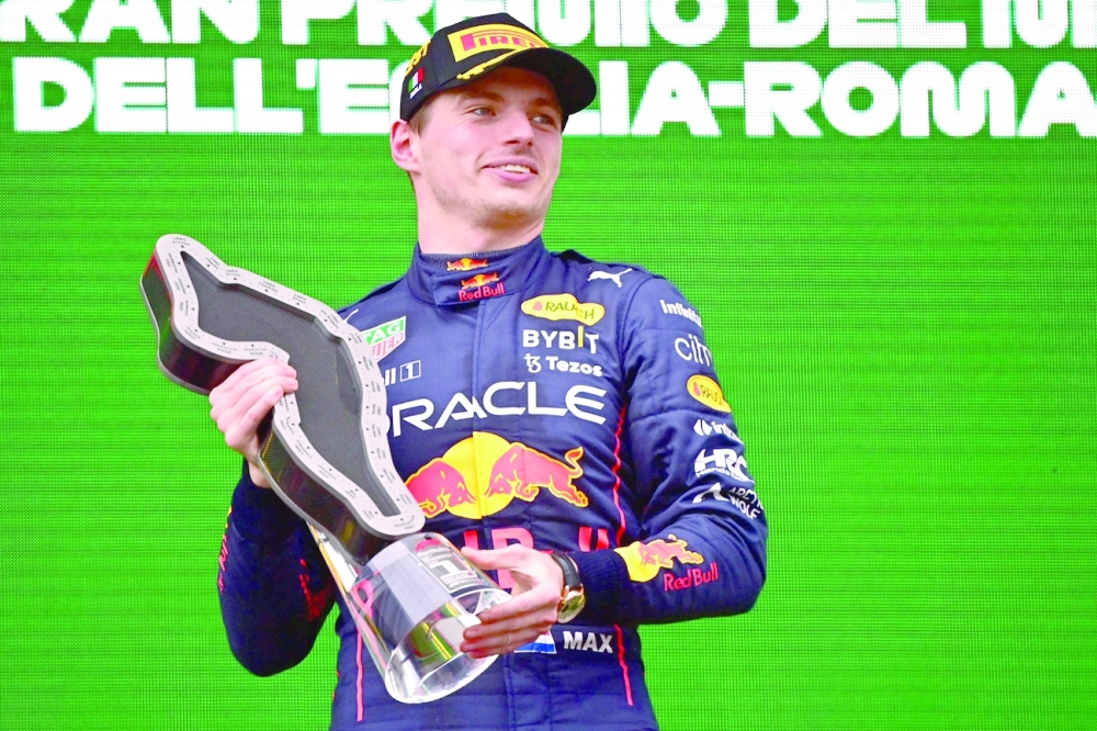 First-placed Red Bull Racing's Dutch driver Max Verstappen celebrates on the podium after the Emilia Romagna Formula One Grand Prix at the Autodromo Internazionale Enzo e Dino Ferrari race track in Imola, Italy, on April 24, 2022.  (Photo by ANDREJ ISAKOVIC / AFP)

