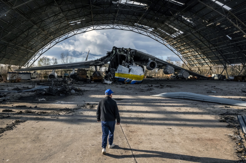 Oleksandr Halunenko, the first pilot of Mriya, surveys damage to the world's largest cargo aircraft at the Antonov airfield in Hostomel, near Kyiv, Ukraine, on Sunday, April 17, 2022. (Daniel Berehulak/The New York Times)