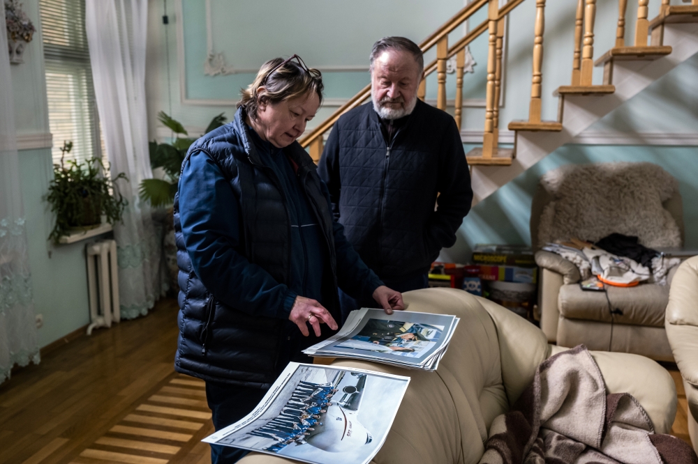 Oleksandr Halunenko reminisces over previous flights on Mriya with his wife, Olha, at their home in Bucha, Ukraine, on Monday, April 18, 2022. (Daniel Berehulak/The New York Times)