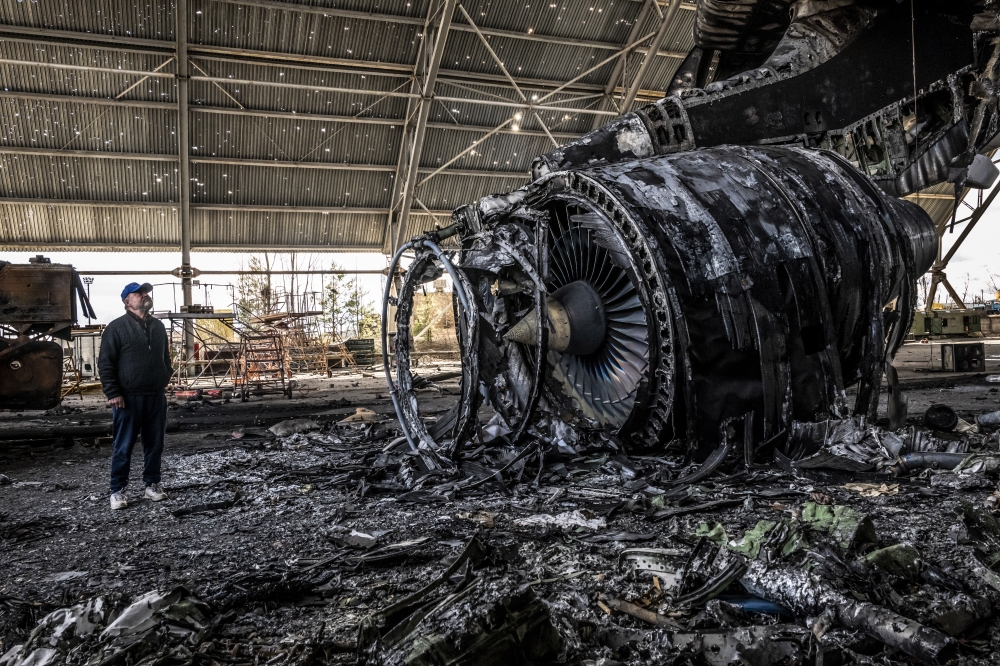Oleksandr Halunenko, the first pilot of Mriya, surveys damage to the world's largest cargo aircraft at the Antonov airfield in Hostomel, near Kyiv, Ukraine, on Sunday, April 17, 2022. (Daniel Berehulak/The New York Times)
