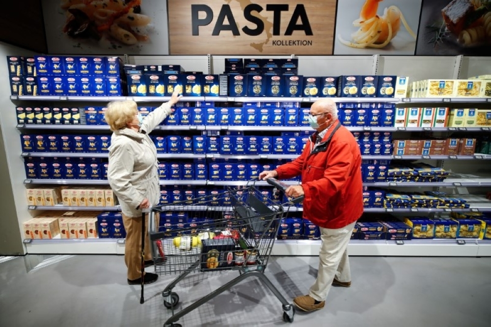 Customers at the Edeka grocery store buy pasta in Duesseldorf, Germany. — Reuters