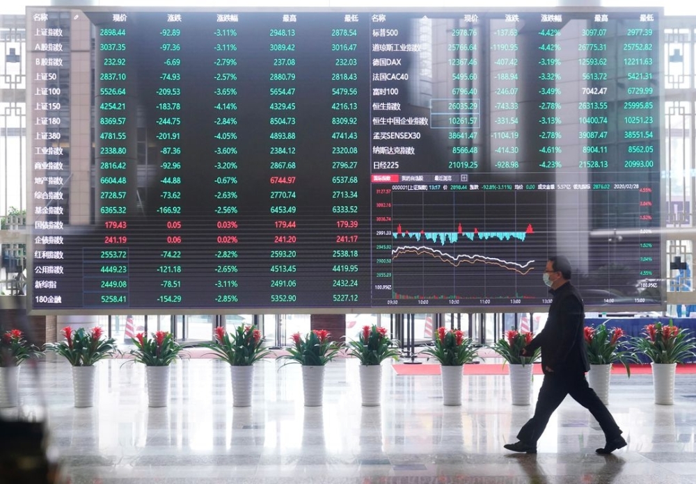 A man wearing a face mask is seen inside Shanghai Stock Exchange. — AFP
