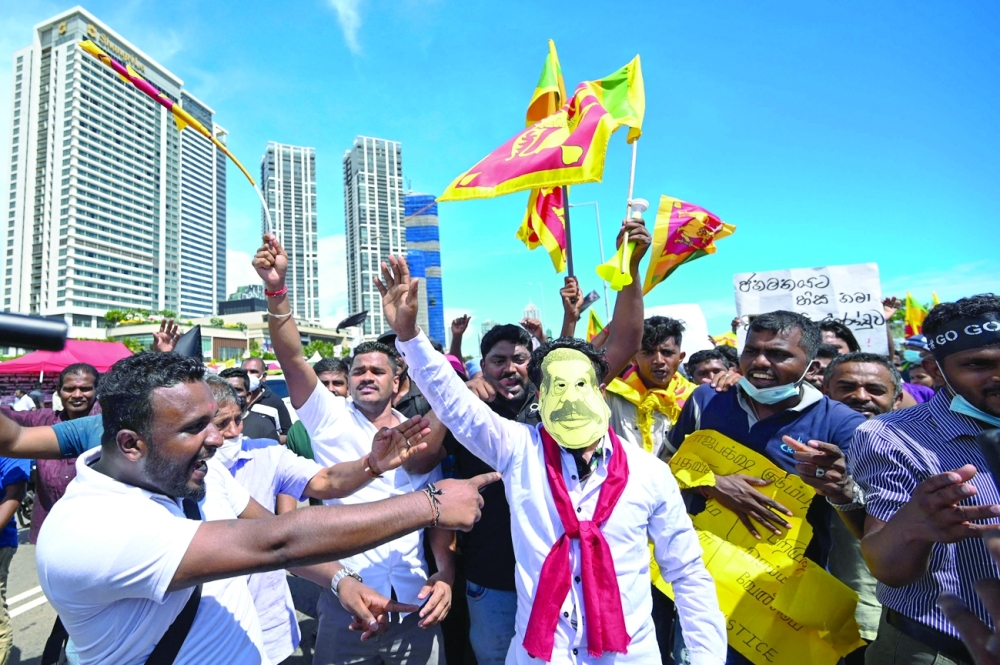 Protesters participate in an ongoing anti-government demonstration outside the President's office in Colombo on Thursday, following a one-day general strike called by trade unions. - AFP