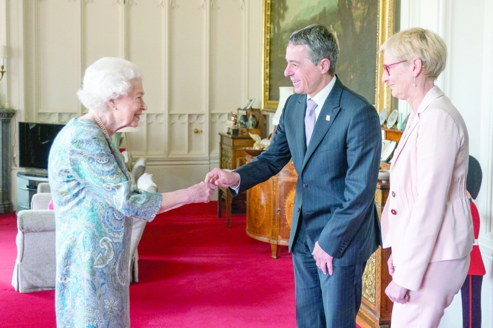 Queen Elizabeth II greets Switzerland's President Ignazio Cassis and his wife Paola Cassis, during an audience at Windsor Castle, west of London on Thursday. - AFP