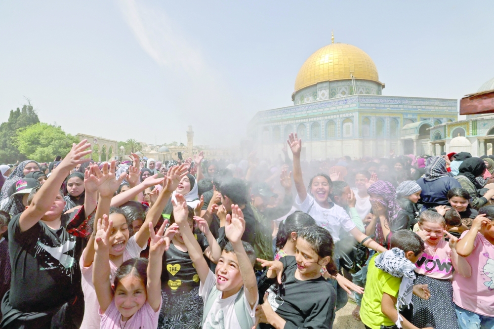 Palestinian worshippers attend the last Friday prayers of Ramadhan, outside the Dome of the Rock mosque at the Al Aqsa mosque compound. - AFP