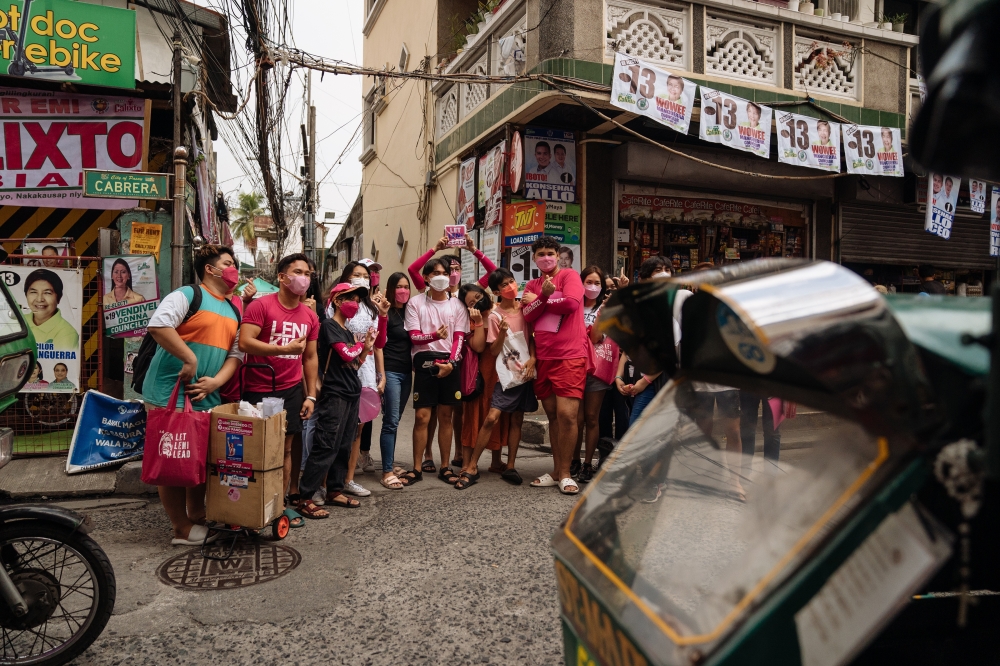 Supporters of Leni Robredo, the vice president of the Philippines who is running for president, prepare to go door to door to campaign for her, in Manila, April 8, 2022. (Hannah Reyes Morales/The New York Times)