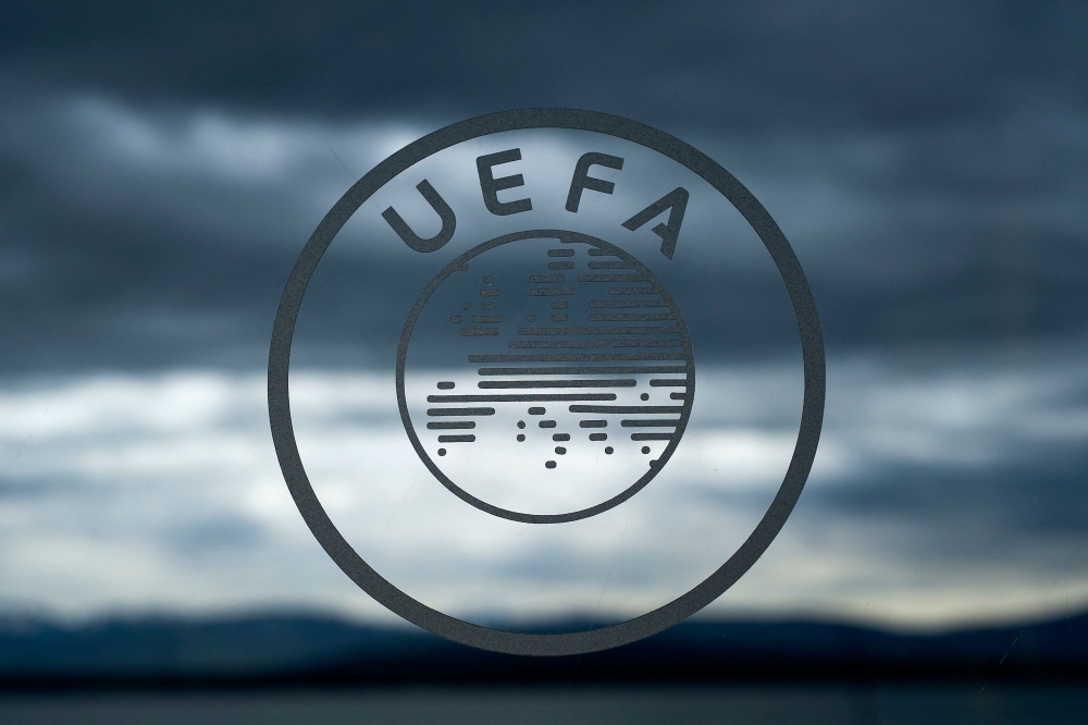 The logo of the UEFA is seen under dark clouds the European fooball governing body's headquarters in Nyon.
