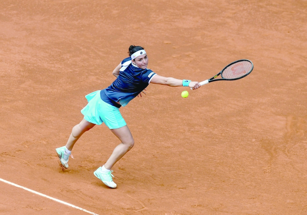 Tunisia's Ons Jabeur returns the ball to Romania's Simona Halep during their 2022 ATP Tour Madrid Open tennis tournament singles match at the Caja Magica in Madrid. — AFP