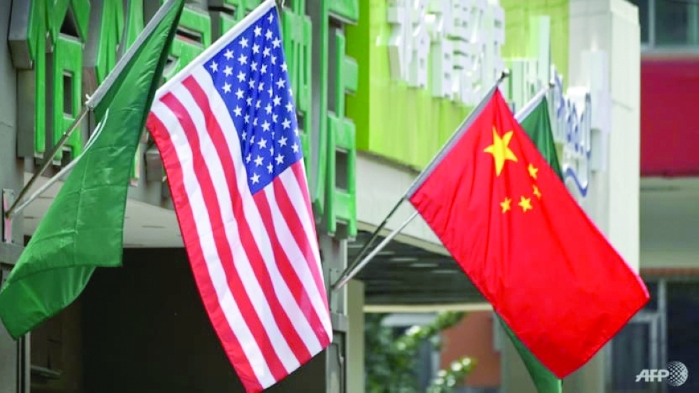 A US and a Chinese flag wave outside a commercial building in Beijing. — AFP