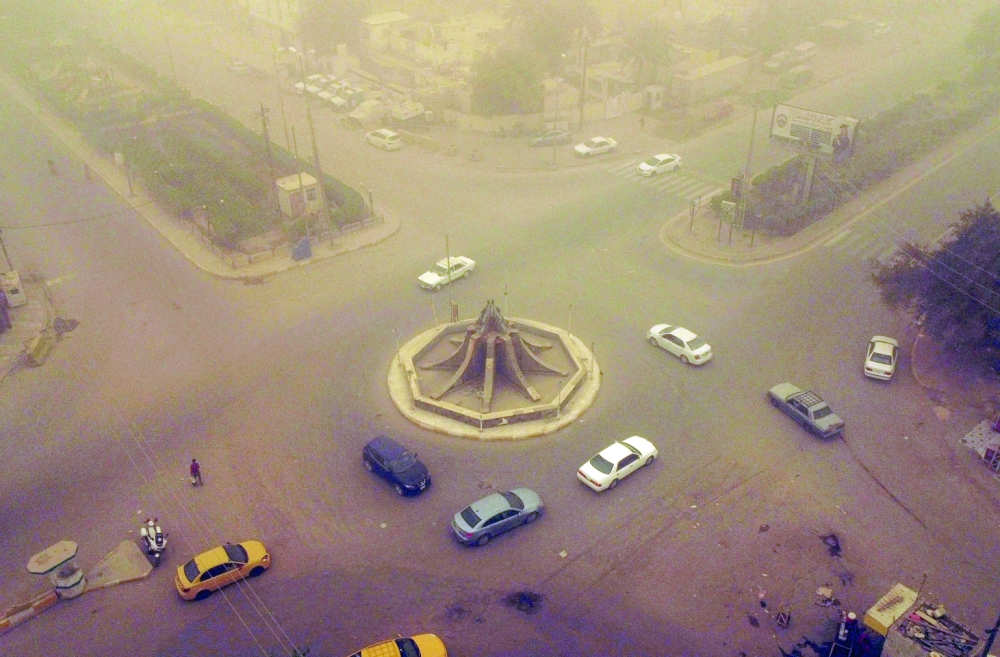 An aerial picture shows a view of Iraq's southern city of Nasiriyah during a heavy sandstorm on Thursday. Iraq was hammered by a series of such storms in April, grounding flights and leaving dozens hospitalised with respiratory problems. -- AFP