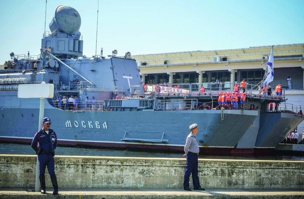 In this file photo taken on August 3, 2013 Cuban police stand watch as the "Moskva" Russian guided missile cruiser moors at Havana's harbour. - AFP