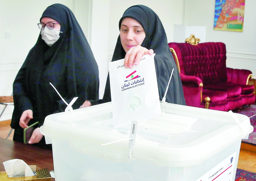 A Lebanese woman casts her ballot at a polling station at the Lebanese Embassy in Tehran, Iran, on Friday. - AFP