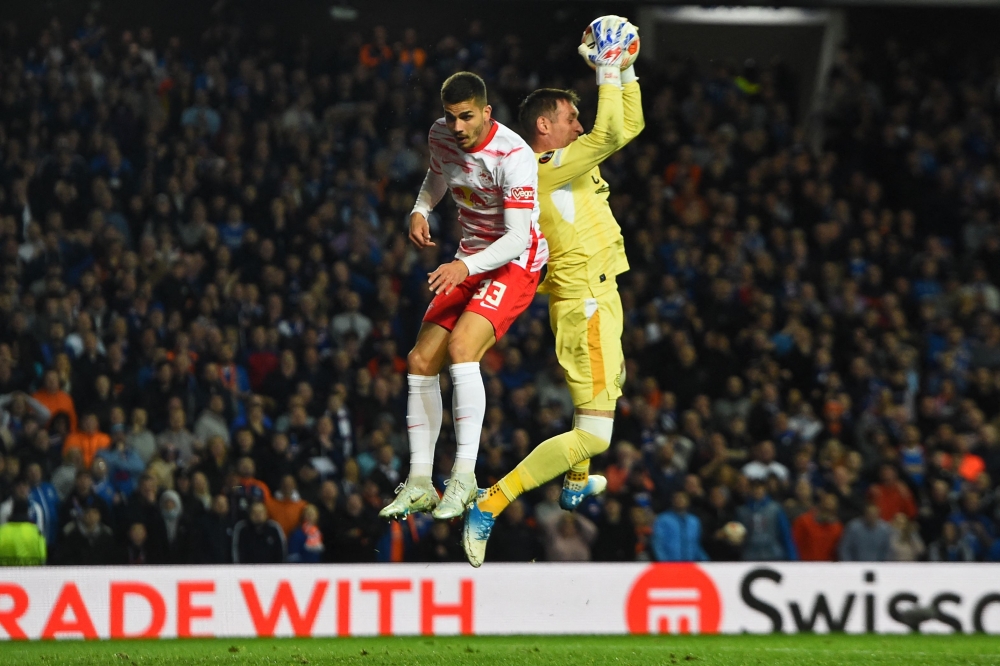 TOPSHOT - Rangers' Scottish goalkeeper Allan McGregor claims the ball under pressure from RB Leipzig's Portuguese striker Andre Silva (L) during the UEFA Europa League Semifinal, second leg football match between Rangers and RB Leipzig at the Ibrox Stadium, in Glasgow, on May 5, 2022. (Photo by ANDY BUCHANAN                        / AFP)