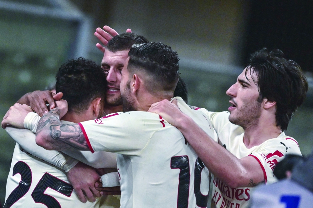 AC Milan's Italian midfielder Alessandro Florenzi (L) celebrates with (From 2ndL) AC Milan's Croatian forward Ante Rebic, AC Milan's French defender Theo Hernandez and AC Milan's Italian midfielder Sandro Tonali after scoring during the Italian Serie A football match between Hellas Verona and AC Milan on May 8, 2022 at the Marcantonio-Bentegodi stadium in Verona. (Photo by MIGUEL MEDINA / AFP)

