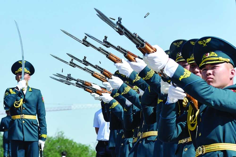 Kyrgyz honour guard soldiers fire a salute at the Eternal Flame monument during Victory Day celebrations in Bishkek. - AFP