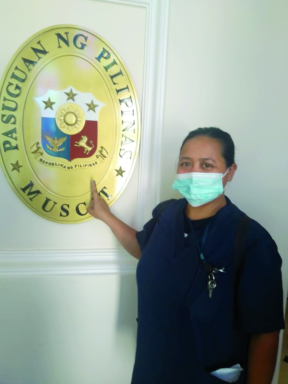 A woman poses for a picture after casting her vote at the Philippines Embassy in Muscat. 