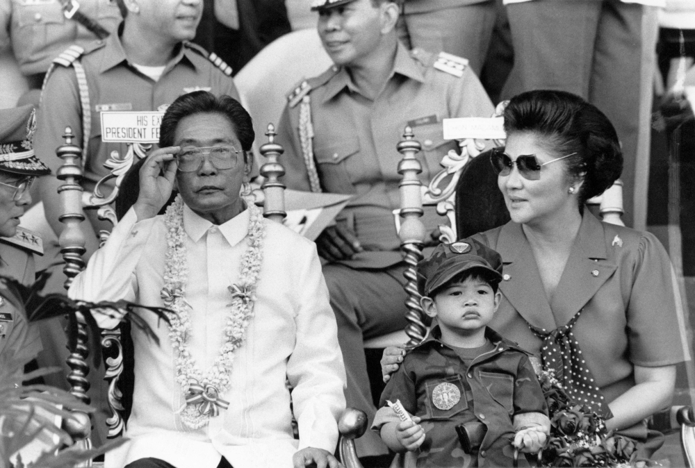 This file photo shows Philippine President Ferdinand Marcos (L) and his wife Imelda appearing before some 35,000 college students undergoing two-year compulsory military training in Manila. 

