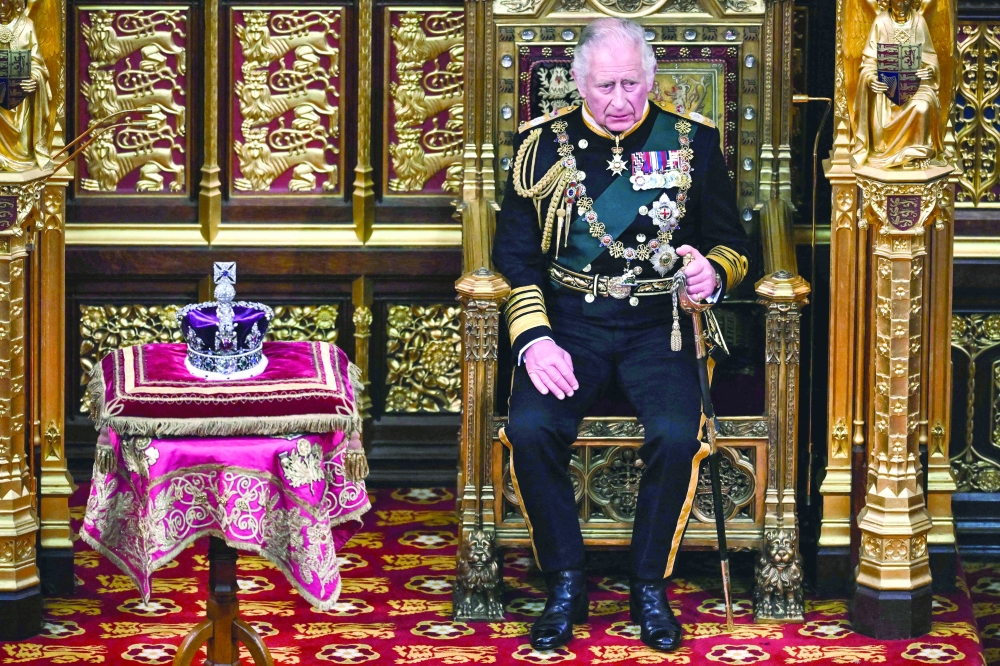 Britain's Prince Charles, Prince of Wales, sits by the The Imperial State Crown in the House of Lords Chamber, during the State Opening of Parliament, in London. - AFP