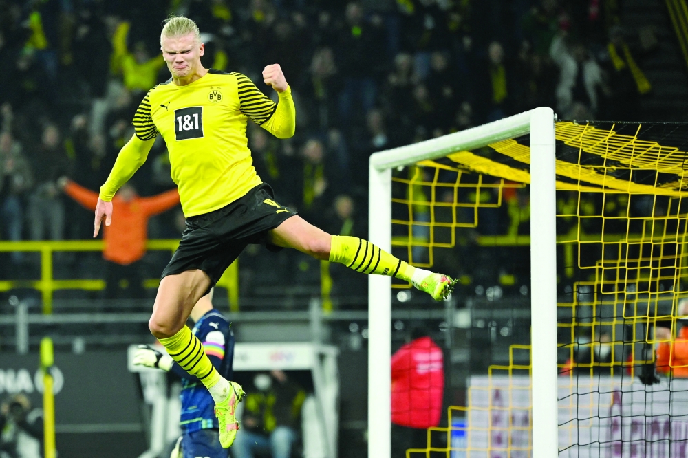 (FILES) In this file photo taken on December 15, 2021 Dortmund's Norwegian forward Erling Braut Haaland celebrates scoring the 2-0 goal during the German first division Bundesliga football match Borussia Dortmund vs SpVgg Greuther Fuerth in Dortmund. Manchester City said on Tuesday, May 10, they had reached an agreement in principle with Borussia Dortmund to sign striker Erling Haaland. - 
 (Photo by Ina Fassbender / AFP)