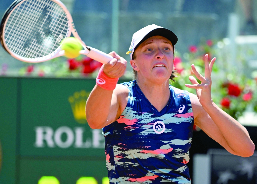 Poland's Iga Swiatek returns to Belarus' Victoria Azarenka during their third round match at the WTA Rome Open tennis tournament on May 12, 2022 at Foro Italico in Rome. (Photo by Tiziana FABI / AFP)

