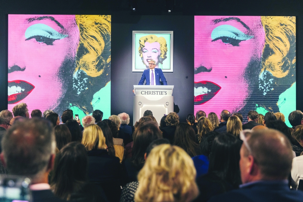A 1964 Andy Warhol silkscreen, Shot Sage Blue Marilyn, is auctioned at Christies on Monday in New York on Monday, May 9, 2022. (Andy Warhol Foundation for the Visual Arts, Inc./Artists Rights Society (ARS), NY; Jeenah Moon/The New York Times) 