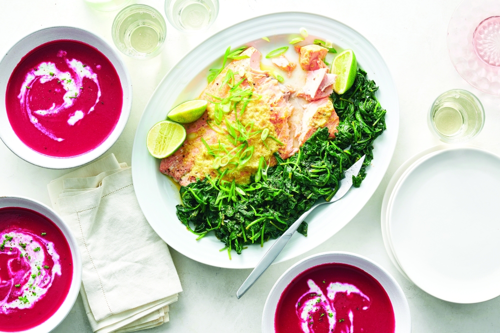 Roasted wild salmon with ginger-lime butter and beet soup with tarragon, chives and yogurt, in New York, April 25, 2022. Food styled by Simon Andrews. (David Malosh/The New York Times)