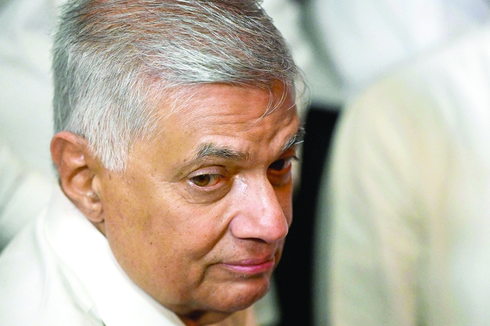 Ranil Wickremesinghe visits a Buddhist temple after his swearing-in ceremony in Colombo on Thursday. - AFP
