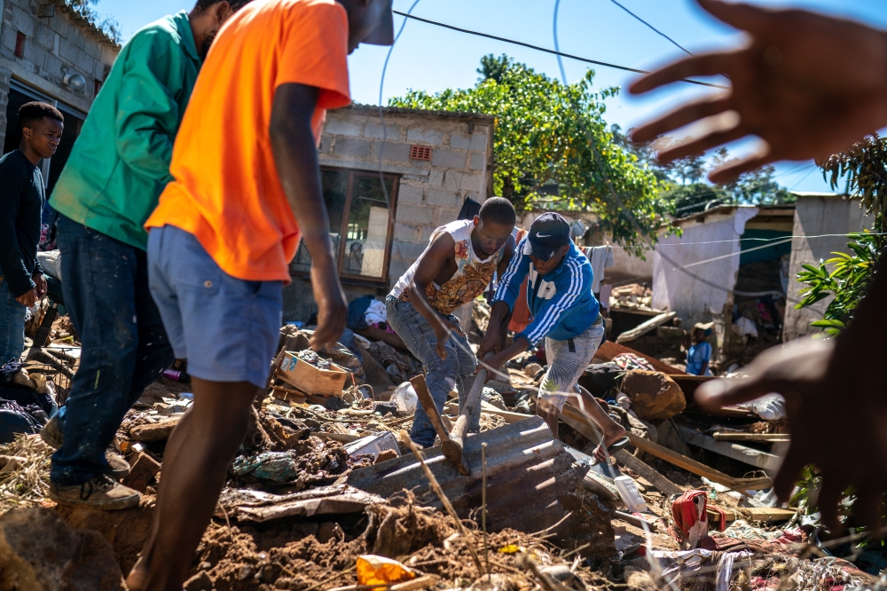 Residents search through rubble and debris for missing relatives in Inanda, a township north of Durban, South Africa, April 20, 2022.  (Joao Silva/The New York Times)