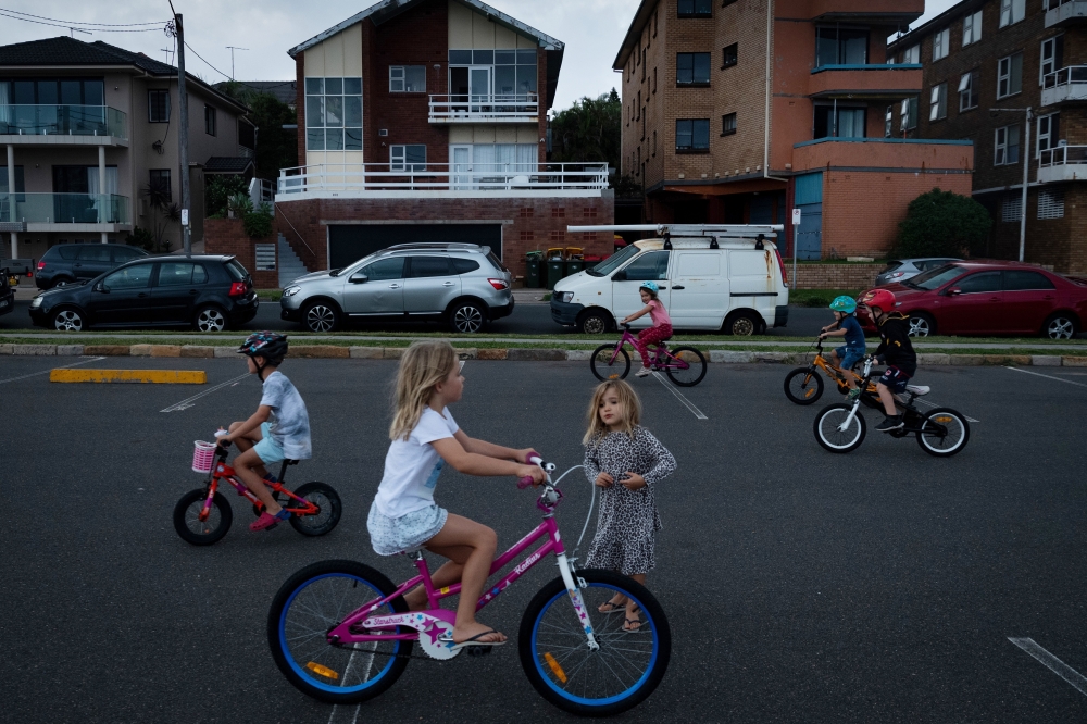 Children play in a parking lot for Maroubra Beach, which was closed during a coronavirus containment lockdown, in Sydney, April 27, 2020. (Matthew Abbott/The New York Times)