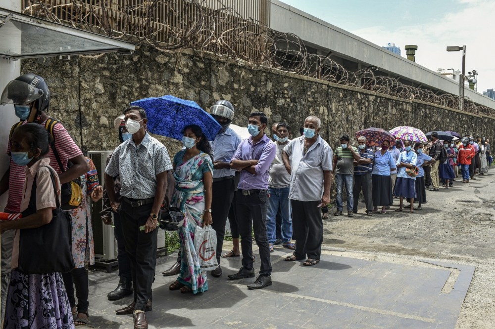 People line up for powdered milk in Colombo, Sri Lanka, on Tuesday, May 17, 2022.  (Atul Loke/The New York Times)