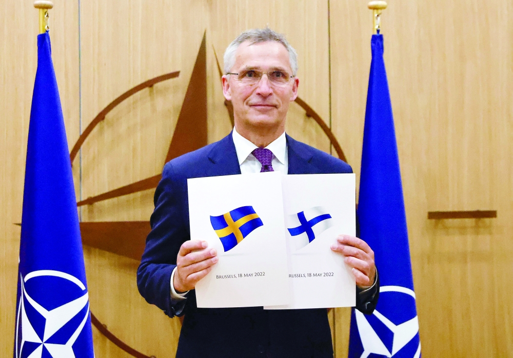 Nato Secretary-General Jens Stoltenberg poses with application documents during a ceremony to mark Sweden's and Finland's application for membership in Brussels. - AFP