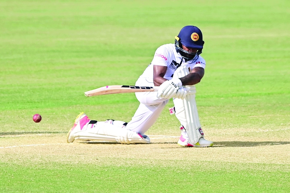 Sri Lanka's Niroshan Dickwella plays a shot during the final day of the first Test cricket match between Bangladesh and Sri Lanka at the Zahur Ahmed Chowdhury Stadium in Chittagong on May 19, 2022. (Photo by Munir uz ZAMAN / AFP)

