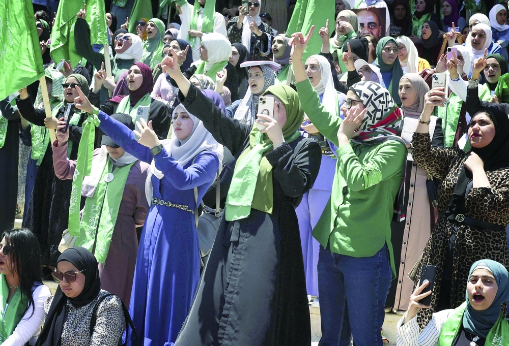 Palestinian students supporting Hamas celebrate a victory in student elections at Birzeit University on Thursday. — AFP