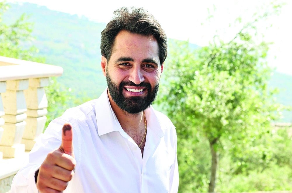 Newly elected MP Firas Hamdan shows his ink-stained thumb during an interview with AFP at his residence in the southern Lebanese village of Kfeir.