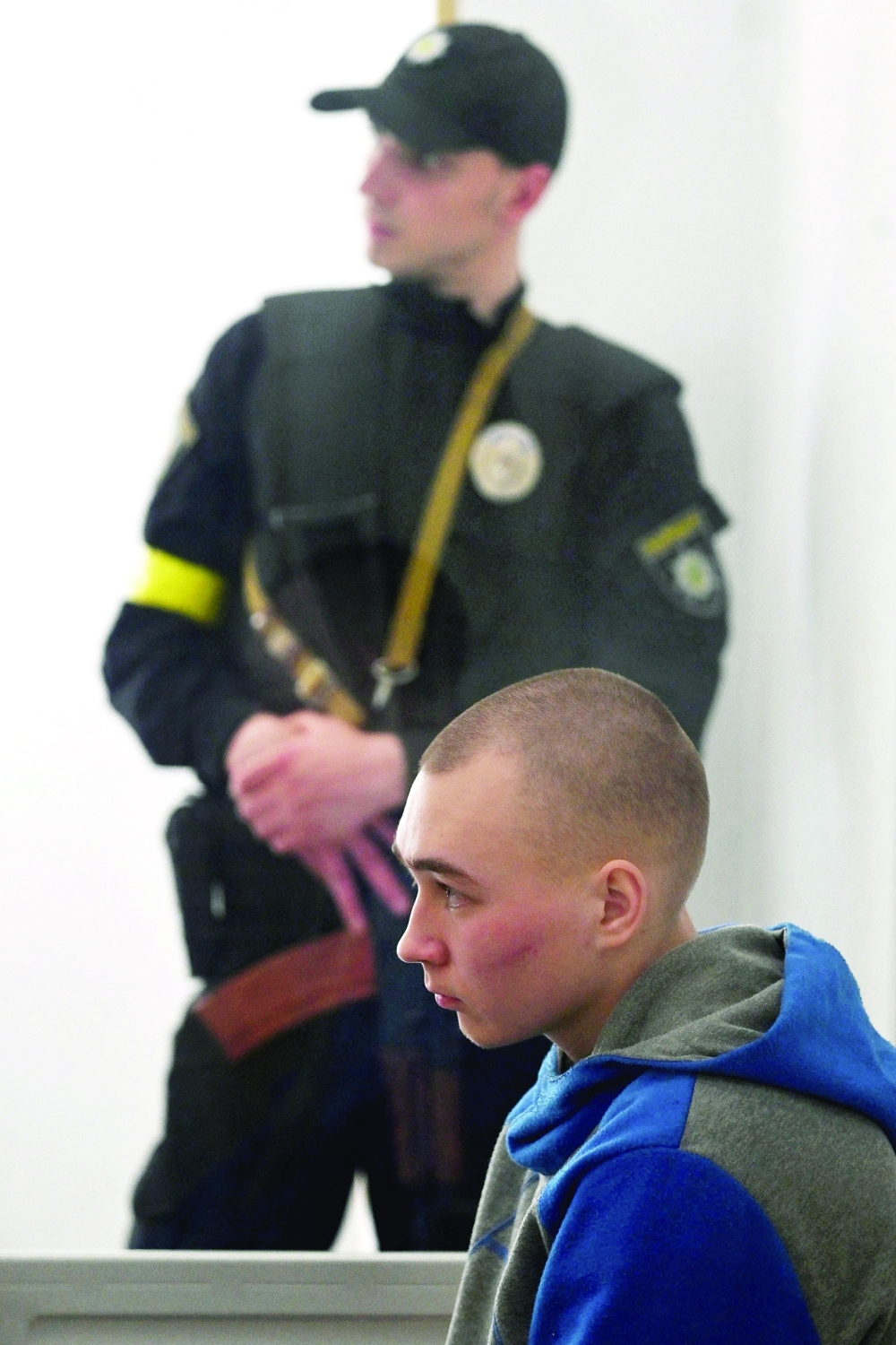 Russian soldier Vadim Shishimarin sits in the defendant's box on the second day of his trial on charges of war crimes for having killed a civilian, in the Solomyansky district court in Kyiv on Thursday. - AFP
