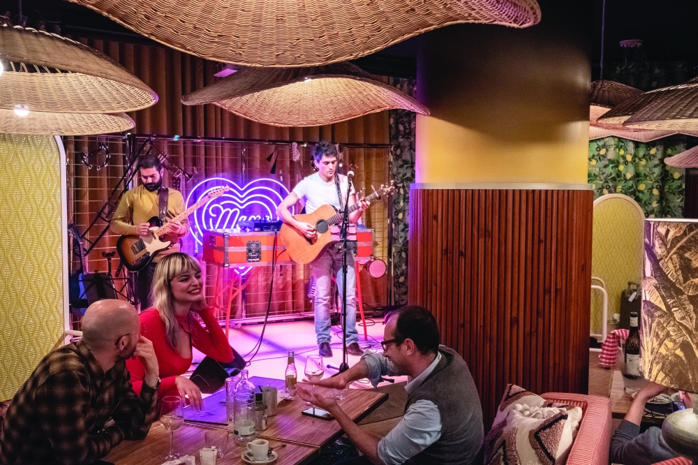 Live music at the kitsch-cool Mama Shelter, a new hotel with a roof bar, co-working space and plant-draped restaurant, in Rome, May 6, 2022. (Francesco Lastrucci/The New York Times)