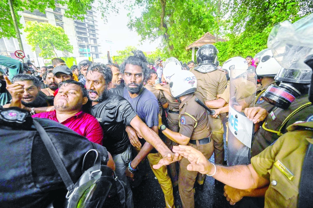 University students and police clash during a demonstration demanding the resignation of Sri Lanka's President Gotabaya Rajapaksa over the country's crippling economic crisis, in Colombo on Thursday. - AFP
