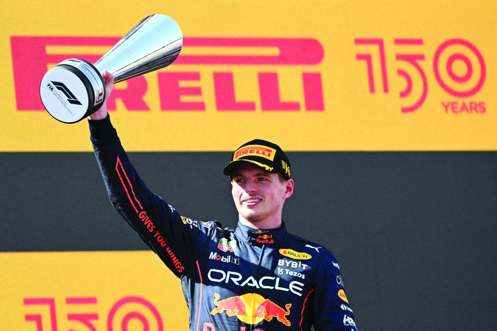 TOPSHOT - Red Bull's Dutch driver Max Verstappen celebrates on the podium after the Spanish Formula One Grand Prix at the Circuit de Catalunya on May 21, 2022 in Montmelo, on the outskirts of Barcelona. (Photo by GABRIEL BOUYS / AFP)


