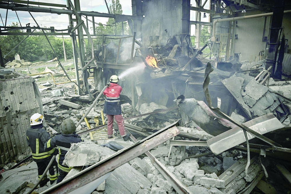 Firemen extinguish a fire at a gypsum manufacturing plant after shelling in the city of Bakhmut at the eastern Ukrainian region of Donbas on Friday. - AFP
