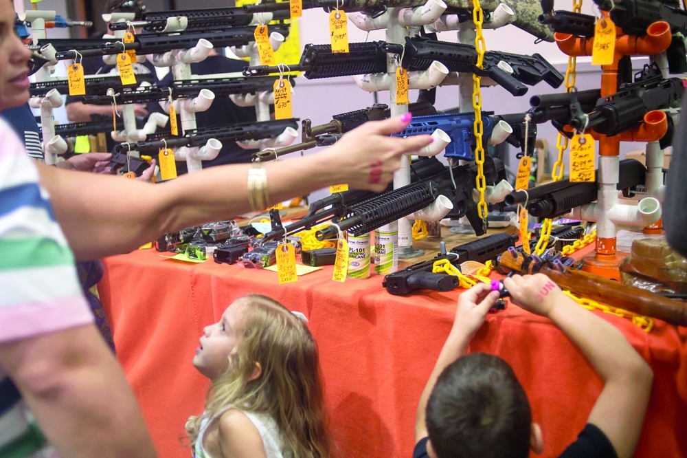 Children at a fairgrounds gun show attended by thousands in Tampa, Florida on Sunday, February 25, 2018.  