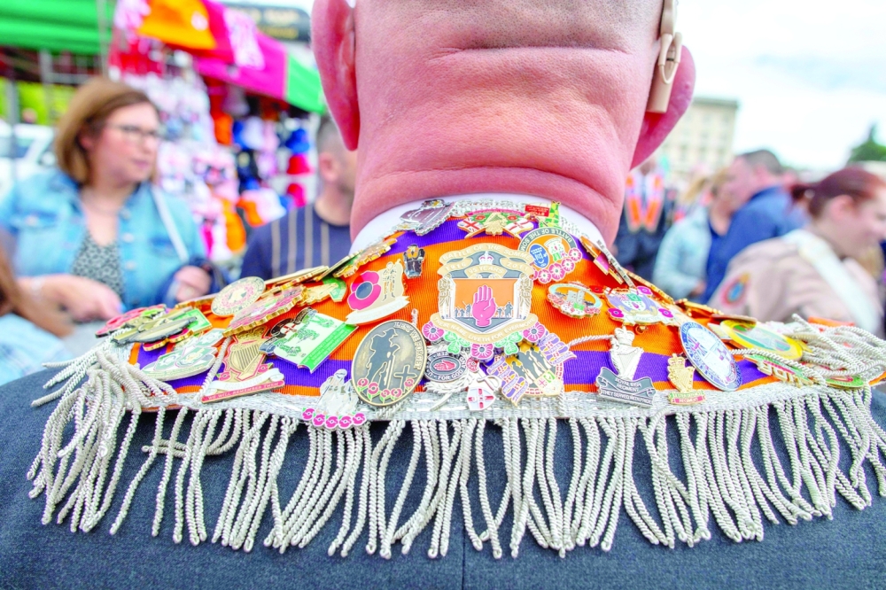 An Orange Order member displays his badges at Stormont as they gather for their Centenary parade, in Belfast on Saturday to mark the hundred years of the formation of the Northern Ireland State. - AFP
