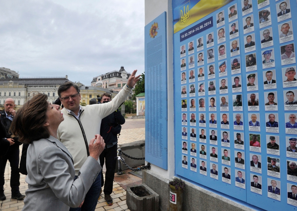 Ukrainian Foreign Minister Dmytro Kuleba and French Foreign Minister Catherine Colonna attend a ceremony at the memorial wall to commemorate Ukrainian servicemen killed during the Russian occupation in Kyiv. - AFP

