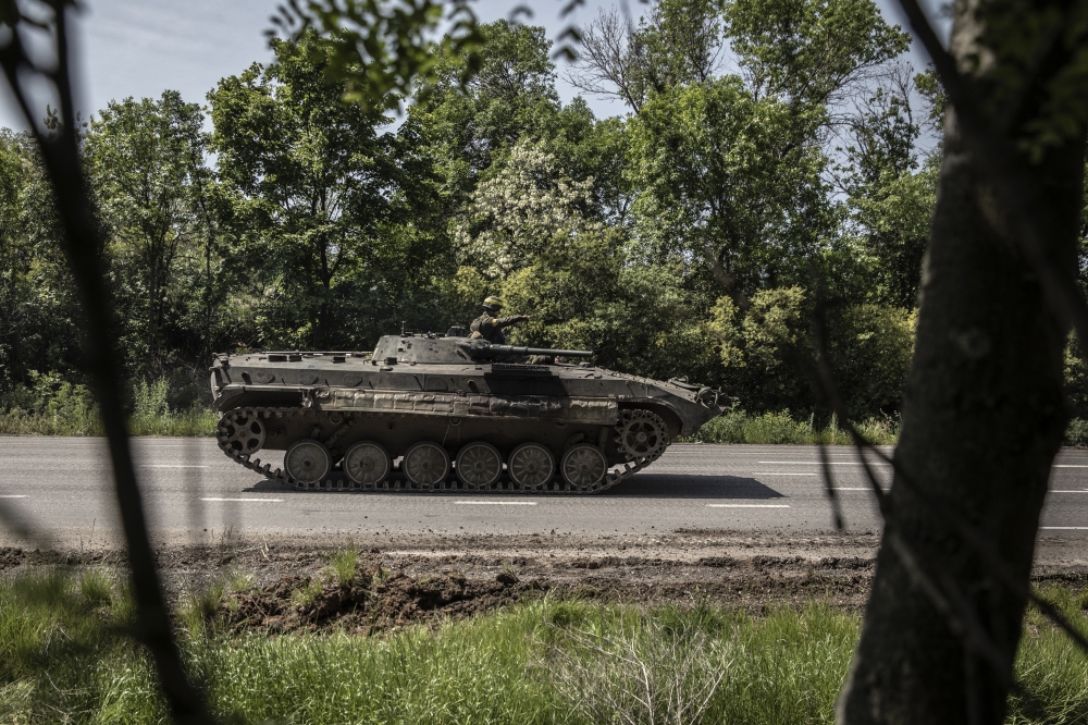 A Ukrainian armoured personnel carrier is driven along a road leading to Sievierodonetsk, in eastern Ukraine, on Monday, May 30, 2022.  (Finbarr O'Reilly/The New York Times)