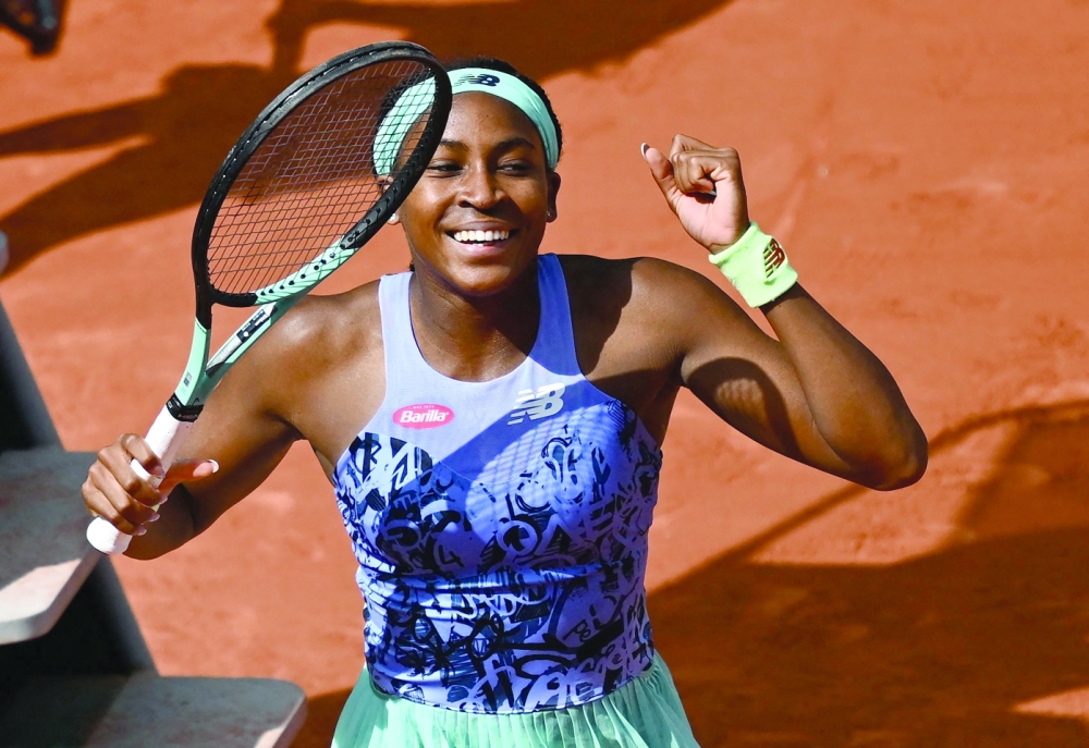 TOPSHOT - US' Coco Gauff reacts after winning against US' Sloane Stephens at the end of their women's singles match on day ten of the Roland-Garros Open tennis tournament at the Court Philippe-Chatrier in Paris on May 31, 2022.  (Photo by Anne-Christine POUJOULAT / AFP)

