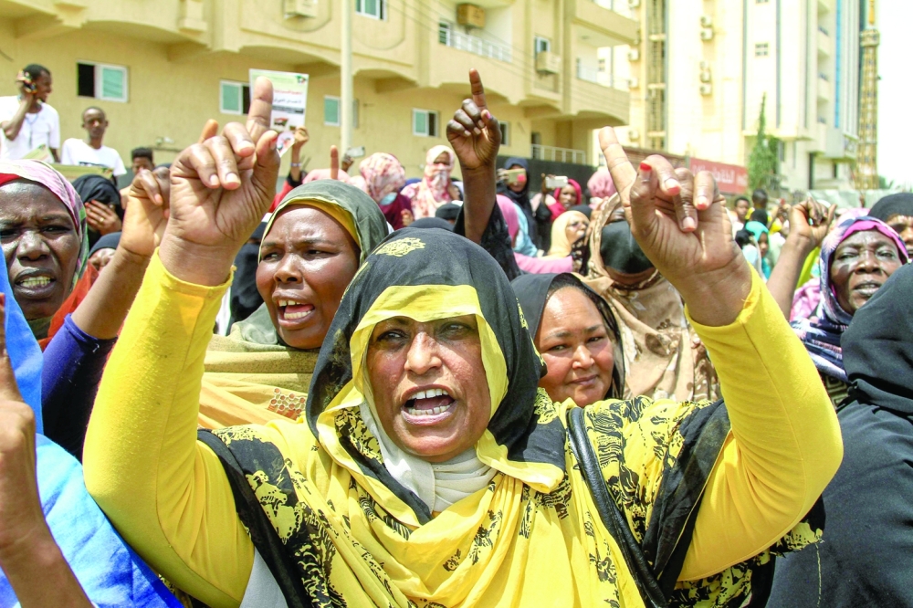 A woman chants slogans as people gather for a protest outside the UN mission in Sudan's capital Khartoum. — AFP