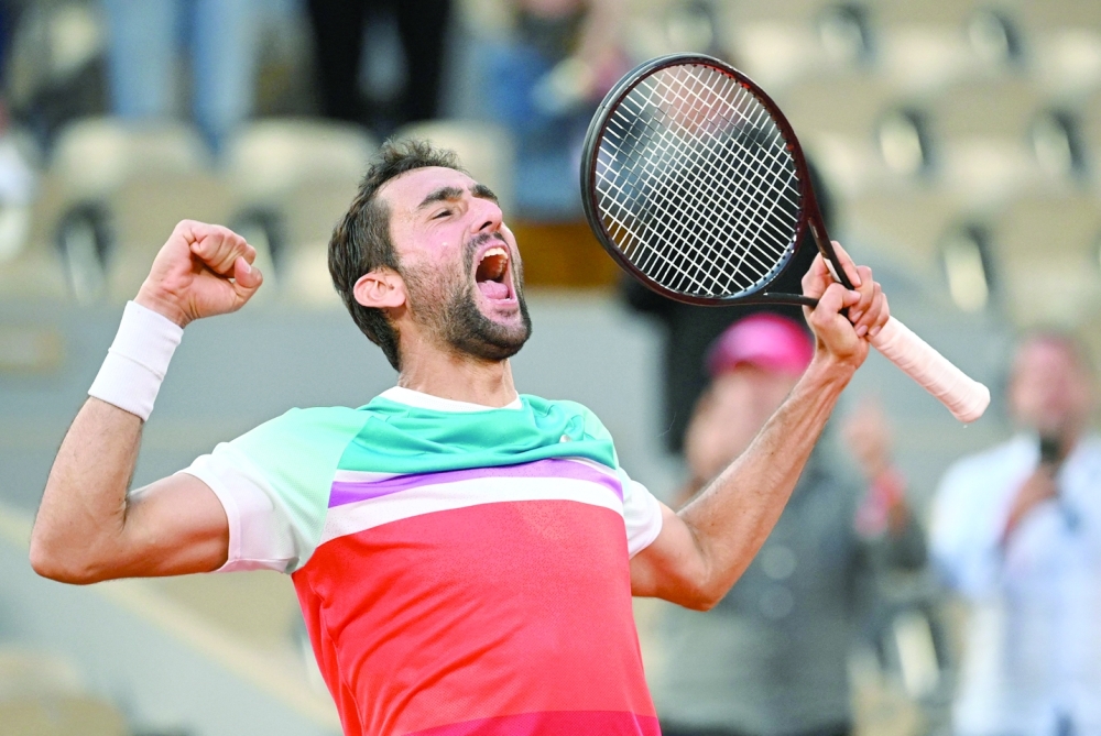 Croatia's Marin Cilic celebrates after victory over Russia's Andrey Rublev in their men's quarterfinal of the Roland-Garros Open at the Court Philippe-Chatrier in Paris. -- AFP